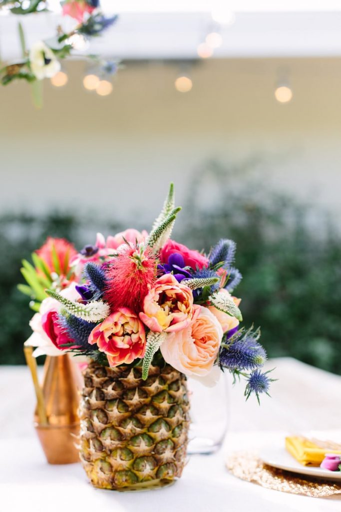 A pineapple used as a flower centerpiece