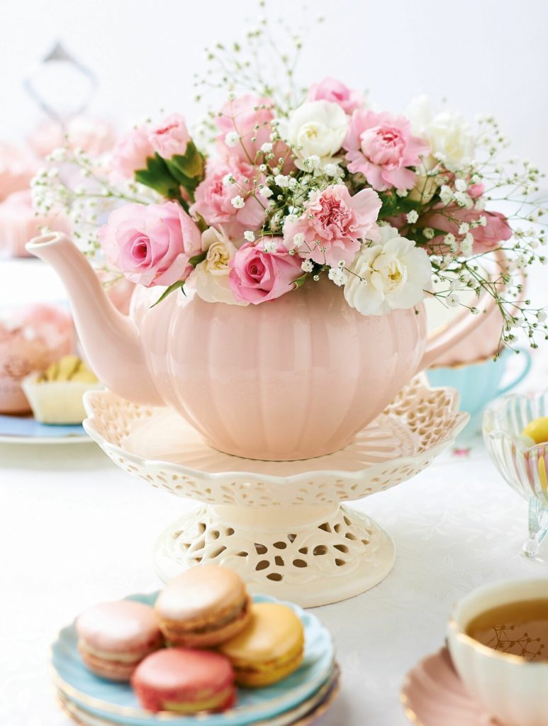 A pink tea pot can be a chic and unique vase idea.